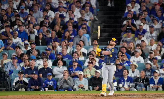 Milwaukee Brewers first baseman Jake Bauers watches his two RBI home run leave the park during the seventh inning of Game 3 of baseball's National League Championship Series between the Milwaukee Brewers and the Los Angeles Dodgers, Wednesday, Oct. 14, 2026, in Los Angeles. (AP Photo/Mark J. Terrill)