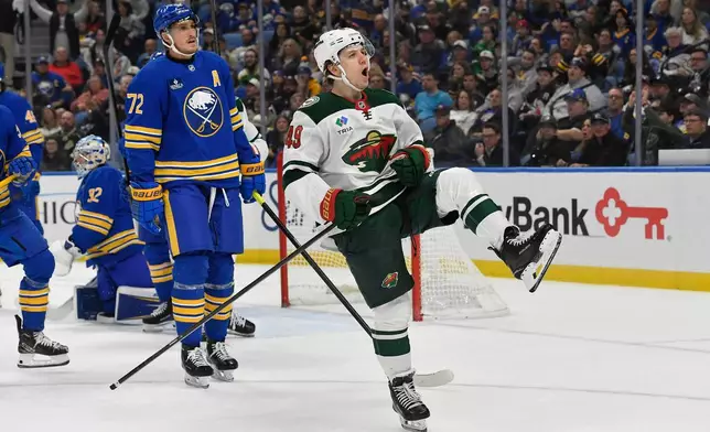 Minnesota Wild right wing Maxim Shabanov, right, celebrates after scoring as Buffalo Sabres center Tage Thompson (72) looks on during the second period of an NHL hockey game Tuesday, Oct. 6, 2026, in Buffalo, N.Y. (AP Photo/Adrian Kraus)