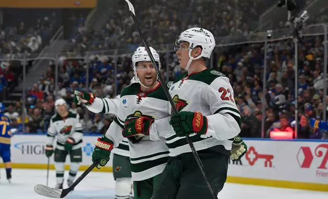 Minnesota Wild right wing Danila Yurov, right, celebrates with left wing Blake Coleman after scoring during the second period of an NHL hockey game against the Buffalo Sabres, Tuesday, Oct. 6, 2026, in Buffalo, N.Y. (AP Photo/Adrian Kraus)