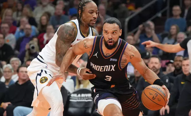 Phoenix Suns forward Dillon Brooks (3) drives around Denver Nuggets guard DeMar DeRozan, left, during the first half of an NBA Cup basketball game, Friday, Oct 30, 2026, in Phoenix. (AP Photo/Rick Scuteri)