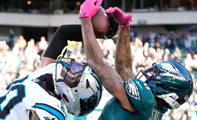 Carolina Panthers safety Zakee Wheatley breaks up a pass intended for Philadelphia Eagles wide receiver DeVonta Smith, right, during the second half of an NFL football game in Philadelphia, Sunday, Oct. 18, 2026. (AP Photo/Chris Szagola)