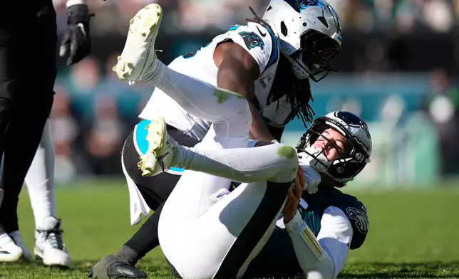 Carolina Panthers linebacker Devin Lloyd sacks Philadelphia Eagles quarterback Tanner McKee during the second half of an NFL football game in Philadelphia, Sunday, Oct. 18, 2026. (AP Photo/Chris Szagola)