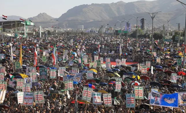 Supporters of Yemen's Houthi rebels raise Yemeni and Iranian flags during a rally in support of the group, in Sanaa, Yemen, Friday, Oct. 9, 2026. Writing on posters reads in Arabic, "God is great, death to America, death to Israel, Curse the Jews, Victory to Islam." (AP Photo/Osamah Abdulrahman)