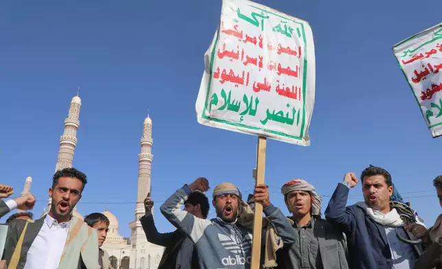 Supporters of Yemen's Houthi rebels shout slogans during a rally in support of the group, in Sanaa, Yemen, Friday, Oct. 9, 2026. The placard reads "God is great, death to America, death to Israel, Curse the Jews, Victory to Islam." (AP Photo/Osamah Abdulrahman)