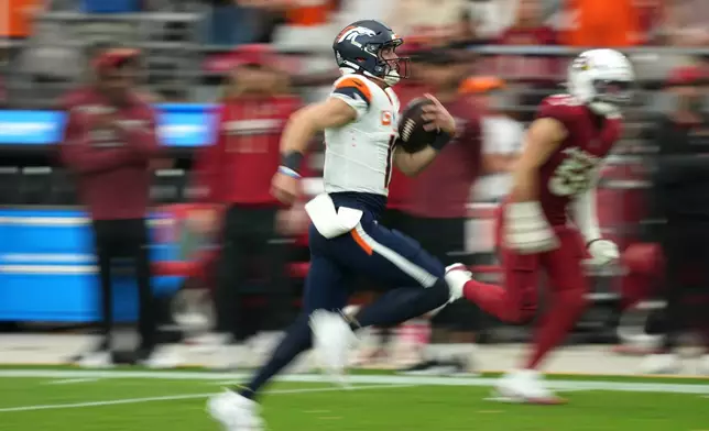 Denver Broncos quarterback Bo Nix (10) runs for a touchdown against the Arizona Cardinals during the first half of an NFL football game in Glendale, Ariz., Sunday, Oct. 25, 2026. (AP Photo/Rick Scuteri)