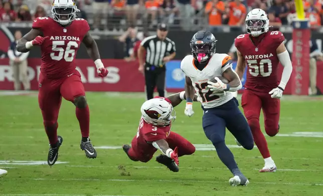 Denver Broncos running back RJ Harvey (12) runs against Arizona Cardinals safety Budda Baker (3) during the second half of an NFL football game in Glendale, Ariz., Sunday, Oct. 25, 2026. (AP Photo/Rick Scuteri)