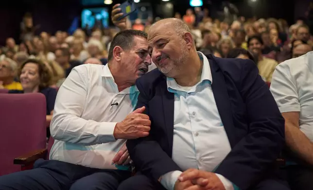 Mansour Abbas, right, leader of the Ra'am party, is joined onstage by Yoav Segalovitz, a former police investigator running second on the party's list, during a campaign event in Tel Aviv, Israel, Friday, Oct. 23, 2026. (AP Photo/David Goldman)