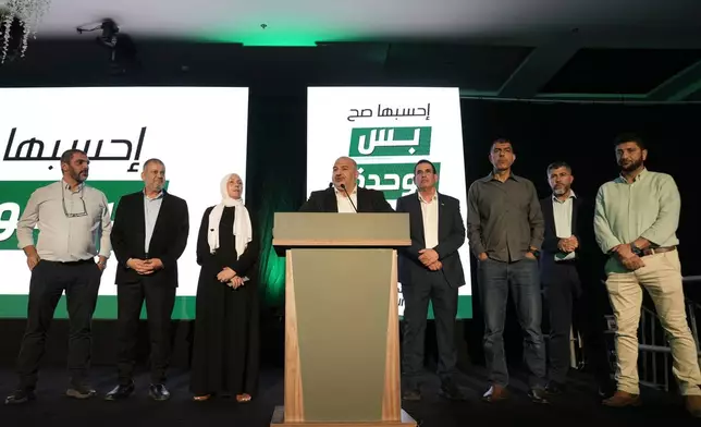 Israeli lawmaker Mansour Abbas, leader of the Ra'am party , centre, speaks to supporters after the release of the first exit poll results in Israel's general election in Sakhnin, Israel, Tuesday, Oct. 27, 2026. (AP Photo/Mahmoud Illean)
