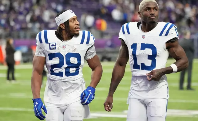 Indianapolis Colts running back Jonathan Taylor (28) and wide receiver Laquon Treadwell (13) react as they walk off the field after an NFL football game against the Minnesota Vikings in Minneapolis, Sunday, Oct. 25, 2026. (AP Photo/Ellen Schmidt)