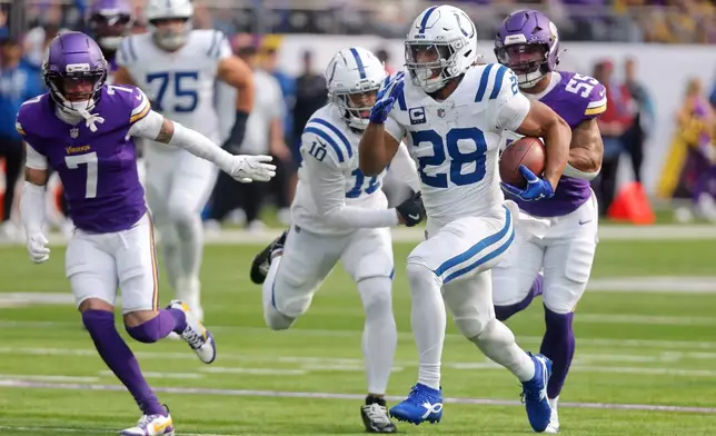 Indianapolis Colts running back Jonathan Taylor (28) runs toward the end zone to score against the Minnesota Vikings during the first half of an NFL football game in Minneapolis, Sunday, Oct. 25, 2026. (AP Photo/Bruce Kluckhohn)