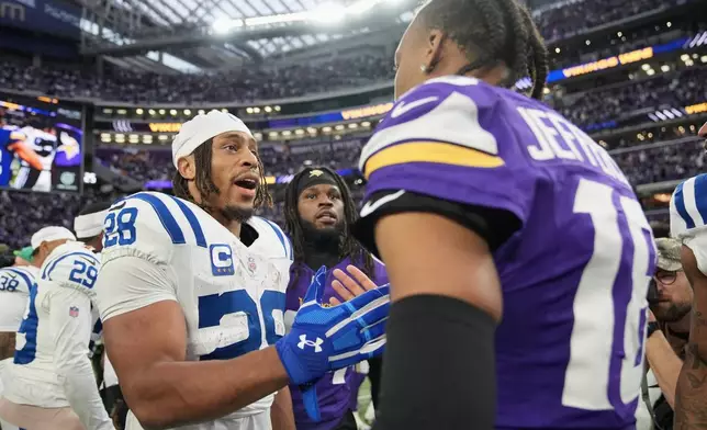 Indianapolis Colts running back Jonathan Taylor (28) greets Minnesota Vikings wide receiver Justin Jefferson after an NFL football game in Minneapolis, Sunday, Oct. 25, 2026. (AP Photo/Ellen Schmidt)