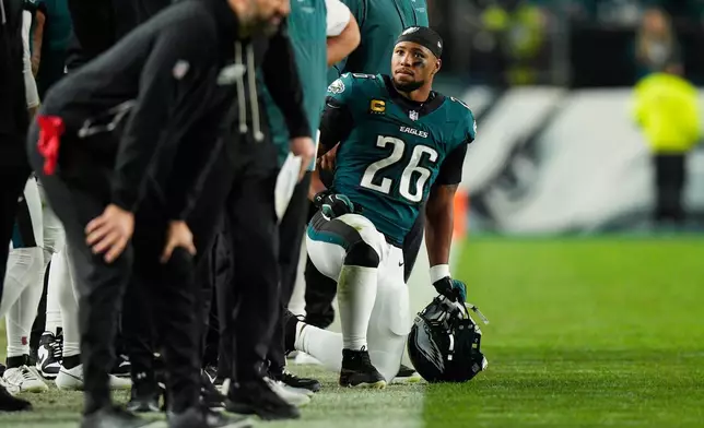 Philadelphia Eagles running back Saquon Barkley (26) kneels on the sidelines during the second half of an NFL football game against the Dallas Cowboys in Philadelphia, Monday, Oct. 26, 2026. (AP Photo/Chris Szagola)