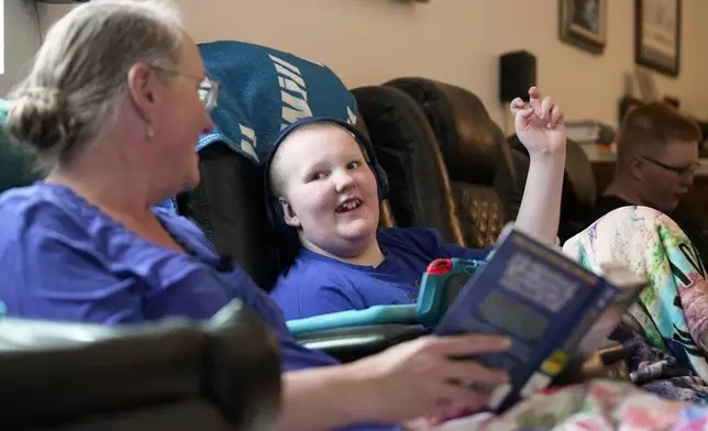 William Walter, 11, and his mother, Katherine, read a book together during homeschooling hours in White Sulphur Springs, Mont., July 16, 2026. (AP Photo/Shelby Lum)