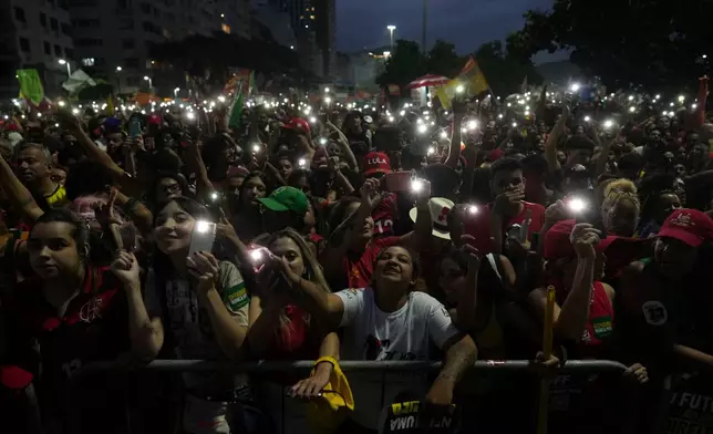 Supporters of Brazilian President Luiz Inacio Lula da Silva, who is running for reelection, watch singer Caetano Veloso perform during a rally one week before the presidential runoff election in Rio de Janeiro, Brazil, Sunday, Oct. 18, 2026. (AP Photo/Silvia Izquierdo)