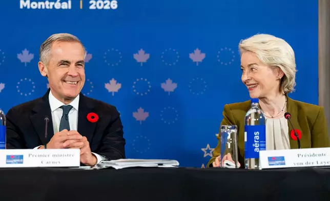 President of the European Commission Ursula von der Leyen, right, gives remarks alongside Canada's Prime Minister Mark Carney at a roundtable with business leaders during the Canada-EU Summit in Montreal, Thursday, Oct. 29, 2026. (Christopher Katsarov/The Canadian Press via AP)