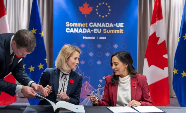 Canada Minister of Foreign Affairs Anita Anand, right and High Representative of the European Union for Foreign Affairs and Security Policy Kaja Kallas sign the Canada-EU Host Country Agreement in Montreal, Thursday, Oct. 29, 2026. (Christopher Katsarov/The Canadian Press via AP)