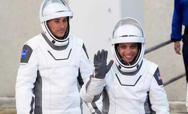Pilot Luke Delaney, left, and commander Jessica Watkins leave the Operations and Checkout Building at the Kennedy Space Center in Cape Canaveral, Fla., Thursday, Oct. 1, 2026. (AP Photo/John Raoux)
