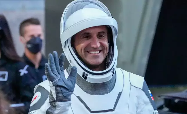 Cosmonaut Sergey Teteryatnikov, of Russia, greets family and friends as he leaves the Operations and Checkout Building at the Kennedy Space Center in Cape Canaveral, Fla., Thursday, Oct. 1, 2026. (AP Photo/John Raoux)