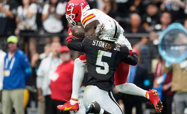 Kansas City Chiefs wide receiver Xavier Worthy makes a catch as Las Vegas Raiders cornerback Eric Stokes Jr. (5) defends during the first half of an NFL football game in Las Vegas, Sunday, Oct. 4, 2026. (AP Photo/John Locher)