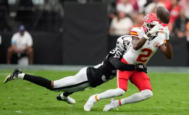Kansas City Chiefs wide receiver Tyquan Thornton (2) tries to make a catch as Las Vegas Raiders cornerback Hezekiah Masses (35) defends during the first half of an NFL football game in Las Vegas, Sunday, Oct. 4, 2026. (AP Photo/John Locher)