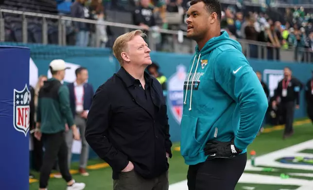 Jacksonville Jaguars defensive tackle Arik Armstead (91) speaks to NFL commissioner, Roger Goodell during the warm-up before an NFL football game against Philadelphia Eagles in London, Sunday, Oct. 11, 2026. (AP Photo/Ian Walton)