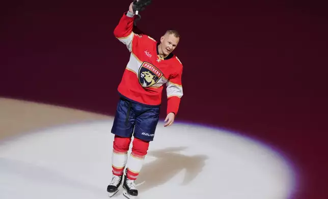 Florida Panthers left wing Brady Tkachuk acknowledges the crowd after scoring a game winning goal during overtime in an NHL hockey game against the Vancouver Canucks, Thursday, Oct. 15, 2026, in Sunrise, Fla. (AP Photo/Lynne Sladky)