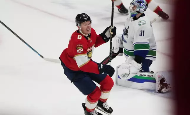 Florida Panthers left wing Brady Tkachuk (8) celebrates after scoring the game winning goal against Vancouver Canucks goaltender Leevi Meriläinen (31) during overtime in an NHL hockey game, Thursday, Oct. 15, 2026, in Sunrise, Fla. (AP Photo/Lynne Sladky)