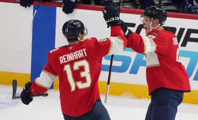 Florida Panthers left wing Brady Tkachuk, right, celebrates with center Sam Reinhart (13) after scoring a goal during the third period of an NHL hockey game against the Vancouver Canucks, Thursday, Oct. 15, 2026, in Sunrise, Fla. (AP Photo/Lynne Sladky)