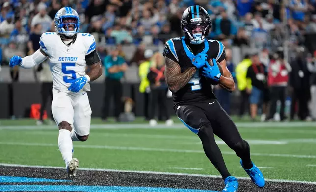 Carolina Panthers wide receiver Tetairoa McMillan (4) scores a touchdown during an NFL football game against the Detroit Lions in Charlotte, N.C., Sunday, Oct. 4, 2026. (AP Photo/Erik Verduzco)