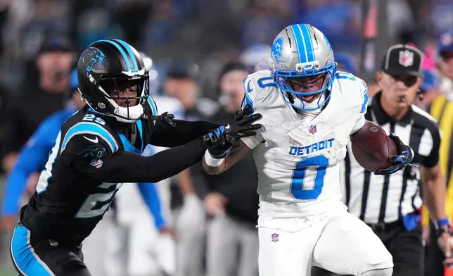 Carolina Panthers cornerback Akayleb Evans (29) pushes Detroit Lions running back Jahmyr Gibbs (0) out of bounds during an NFL football game in Charlotte, N.C., Sunday, Oct. 4, 2026. (AP Photo/Jacob Kupferman)