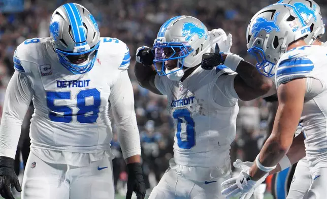 Detroit Lions running back Jahmyr Gibbs (0) celebrates after he scores a touchdown during an NFL football game against the Carolina Panthers in Charlotte, N.C., Sunday, Oct. 4, 2026. (AP Photo/Jacob Kupferman)