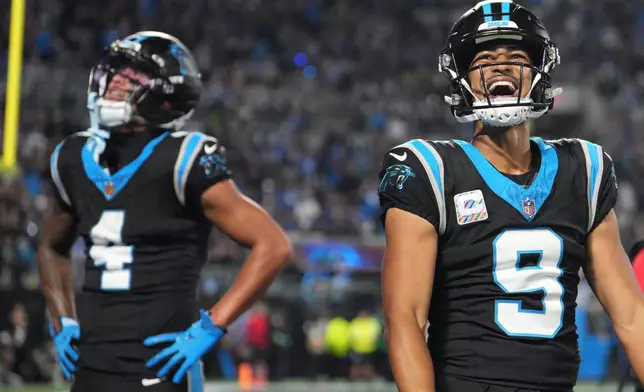 Carolina Panthers quarterback Bryce Young (9) celebrates after Carolina Panthers wide receiver Tetairoa McMillan (4) scores a touchdown during an NFL football game against the Detroit Lions in Charlotte, N.C., Sunday, Oct. 4, 2026. (AP Photo/Erik Verduzco)