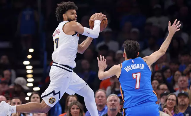 Denver Nuggets guard Jamal Murray, left, secures a rebound near Oklahoma City Thunder center Chet Holmgren, right, during the first half of an NBA basketball game Thursday, Oct. 22, 2026, in Oklahoma City. (AP Photo/Nate Billings)