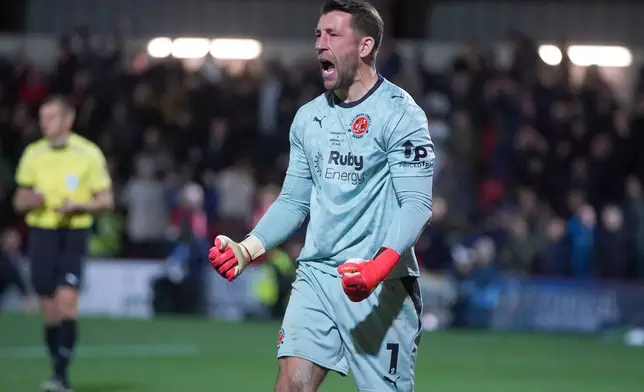 Fleetwood's goalkeeper Jay Lynch celebrates during penalty shootout during the English League Cup soccer match between Fleetwood Town and Arsenal in Fleetwood, England, Tuesday, Oct. 27, 2026. (AP Photo/Ian Hodgson)