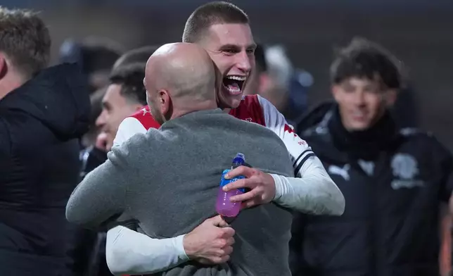 Fleetwood's coach Matt Lawlor celebrates with his players after winning a penalty shootout during the English League Cup soccer match between Fleetwood Town and Arsenal in Fleetwood, England, Tuesday, Oct. 27, 2026. (AP Photo/Ian Hodgson)