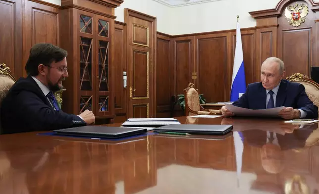 Russian President Vladimir Putin, right, listens to head of the Delovaya Rossiya (Business Russia) National Public Organisation Alexei Repik during their meeting at the Kremlin in Moscow, Monday, Oct. 12, 2026. (Mikhail Metzel, Sputnik, Kremlin Pool Photo via AP)