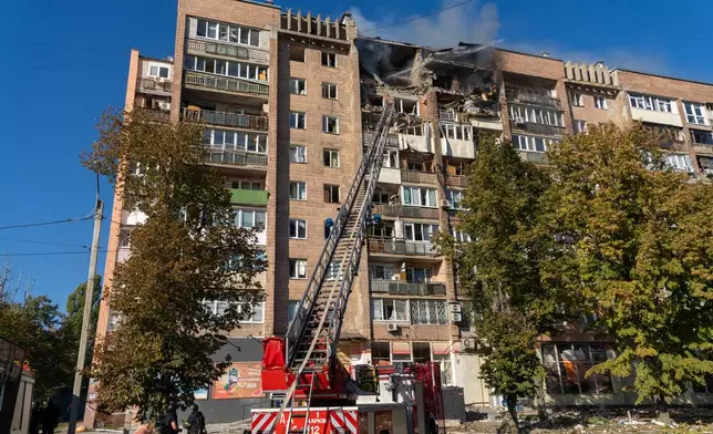 A residential building burns following a Russian air attack in Kharkiv, Ukraine, Monday, Oct. 12, 2026. (AP Photo/Andrii Marienko)