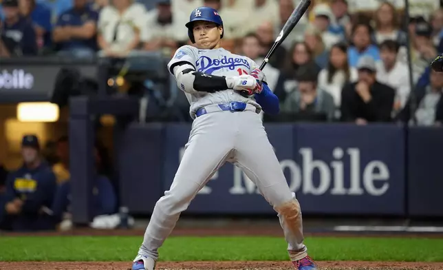 Los Angeles Dodgers designated hitter Shohei Ohtani leans back on an inside pitch during the eighth inning of Game 1 of baseball's National League Championship Series between the Milwaukee Brewers and the Los Angeles Dodgers, Sunday, Oct. 11, 2026, in Milwaukee. (AP Photo/Abbie Parr)