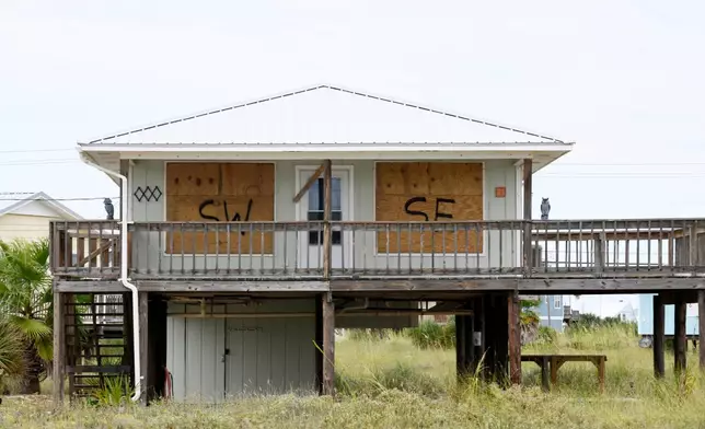 A home is boarded up with plywood ahead of Hurricane Isaias’ expected landfall along the Gulf Coast in Dauphin Island, Alabama, Thursday, Oct. 8, 2026. (AP Photo/Octavio Jones)