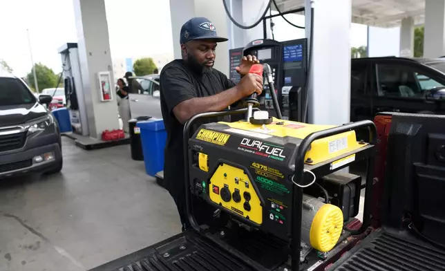A resident refuels his generator at the Costco Wholesale gas station ahead of Hurricane Isaias' expected landfall along the Gulf Coast in Mobile, Alabama, Thursday, Oct. 8, 2026. (AP Photo/Octavio Jones)