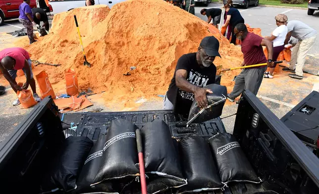 Residents pick up sandbags for storm preparation at the James Seals Jr. Parks & Recreation Center ahead of Hurricane Isaias' expected landfall along the Gulf Coast, Thursday, Oct. 8, 2026, in Mobile, Ala. (AP Photo/Octavio Jones)