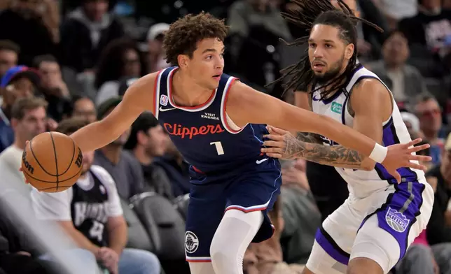 Los Angeles Clippers guard Keaton Wagler (1) is defended by Sacramento Kings guard Emanuel Sharp during an NBA basketball game Wednesday, Oct. 21, 2026, in Los Angeles. (AP Photo/Jayne Kamin-Oncea)