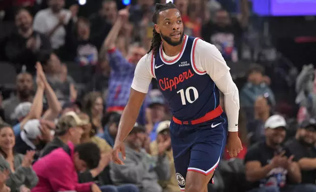 Los Angeles Clippers' Darius Garland heads down court after a 3-point basket during an NBA basketball game against the Sacramento Kings, Wednesday, Oct. 21, 2026, in Los Angeles. (AP Photo/Jayne Kamin-Oncea)