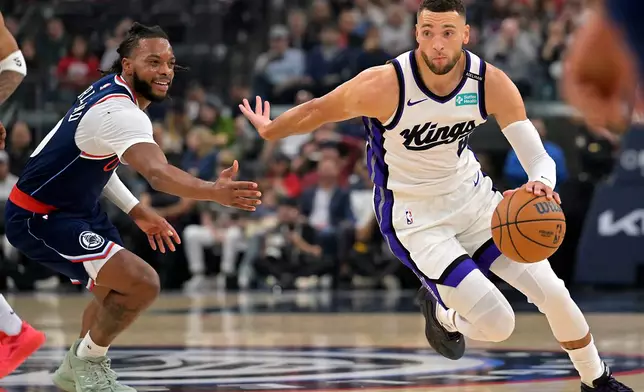 Sacramento Kings guard Zach LaVine (8) drives past Los Angeles Clippers guard Darius Garland during the first half of an NBA basketball game Wednesday, Oct. 21, 2026, in Los Angeles. (AP Photo/Jayne Kamin-Oncea)