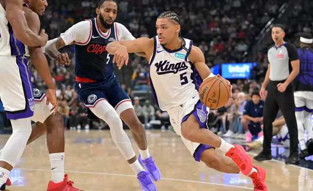 Sacramento Kings guard Darius Acuff Jr. is defended by Los Angeles Clippers forward Derrick Jones Jr. (5) during the first half of an NBA basketball game Wednesday, Oct. 21, 2026, in Los Angeles. (AP Photo/Jayne Kamin-Oncea)
