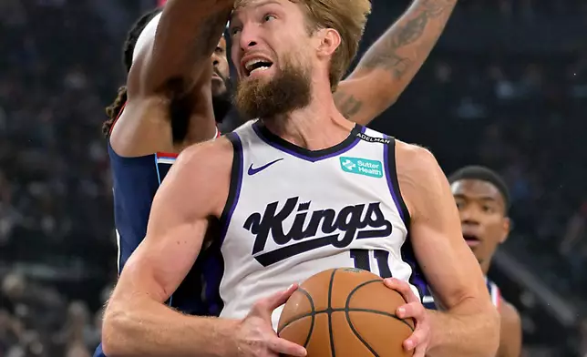 Sacramento Kings center Domantas Sabonis (11) is defended by Los Angeles Clippers forward Isaiah Jackson during the first half of an NBA basketball game Wednesday, Oct. 21, 2026, in Los Angeles. (AP Photo/Jayne Kamin-Oncea)