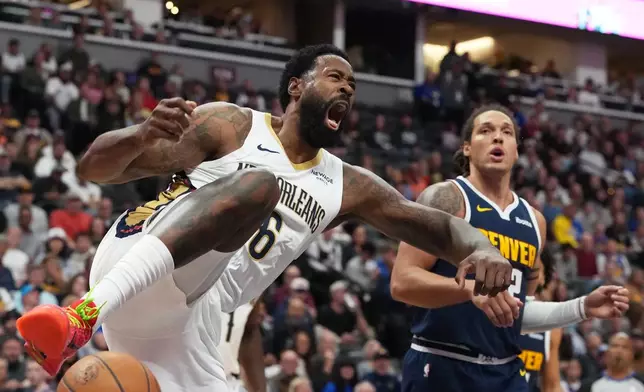 New Orleans Pelicans center DeAndre Jordan, left reacts after dunking the ball for a basket as Denver Nuggets forward Aaron Gordon looks on in the first half of an NBA basketball game Saturday, Oct. 24, 2026, in Denver. (AP Photo/David Zalubowski)