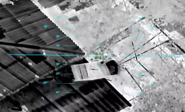 In this undated image from video provided by the Ukrainian 34th Separate Marine Brigade "Borysfen" on Oct. 4, 2026, a drone drops a parcel of supplies to civilians in the Russian-occupied city of Oleshky in the Kherson region of Ukraine. (Ukrainian 34th Separate Marine Brigade "Borysfen" via AP)