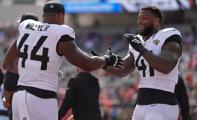 Jacksonville Jaguars defensive end Travon Walker (44) and Jacksonville Jaguars defensive end Josh Hines-Allen (41) before an NFL football game in Cincinnati, Sunday, Oct. 4, 2026. (AP Photo/Joshua A. Bickel)