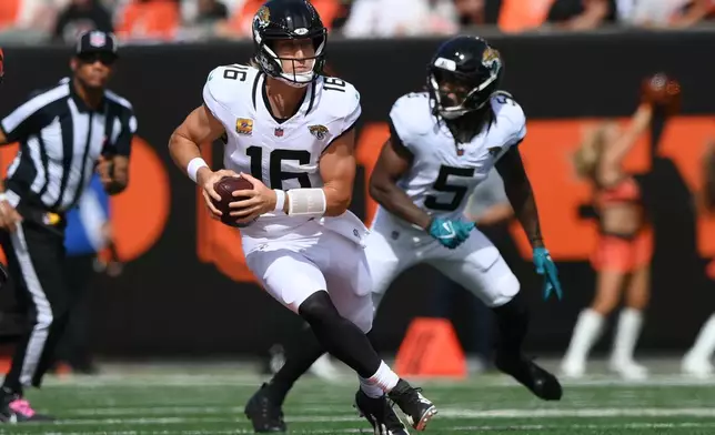 Jacksonville Jaguars quarterback Trevor Lawrence (16) runs the ball during an NFL football game against the Cincinnati Bengals in Cincinnati, Sunday, Oct. 4, 2026. (AP Photo/Tanner Pearson)